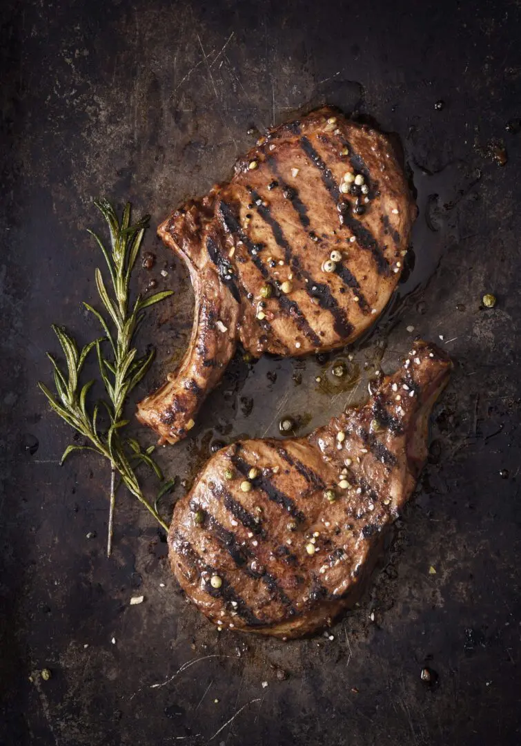 Grilled ribeye steaks with rosemary and peppercorns