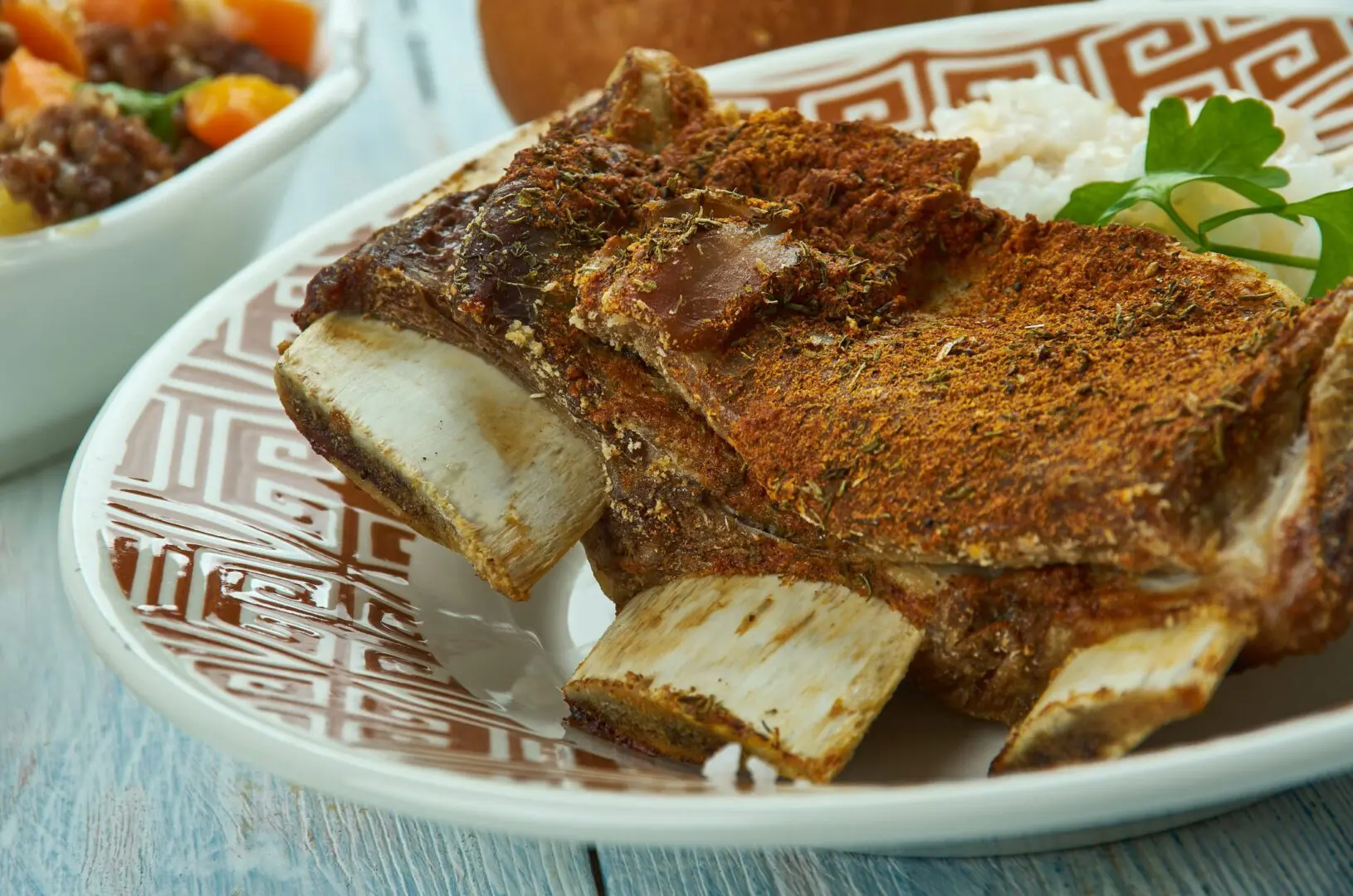 Seasoned beef short ribs on patterned plate