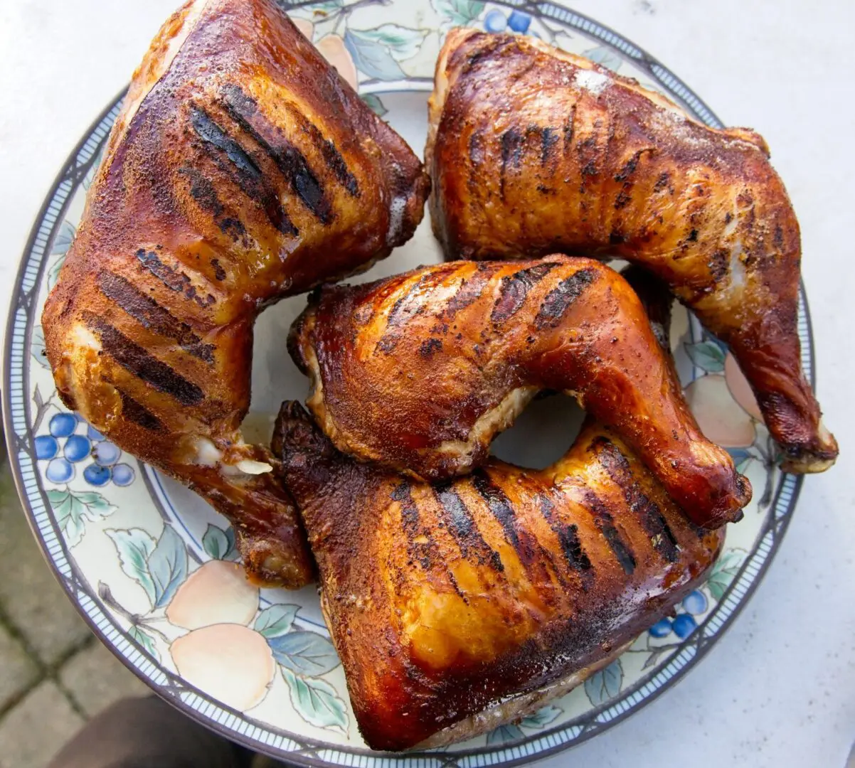 Grilled chicken quarters with charred grill marks