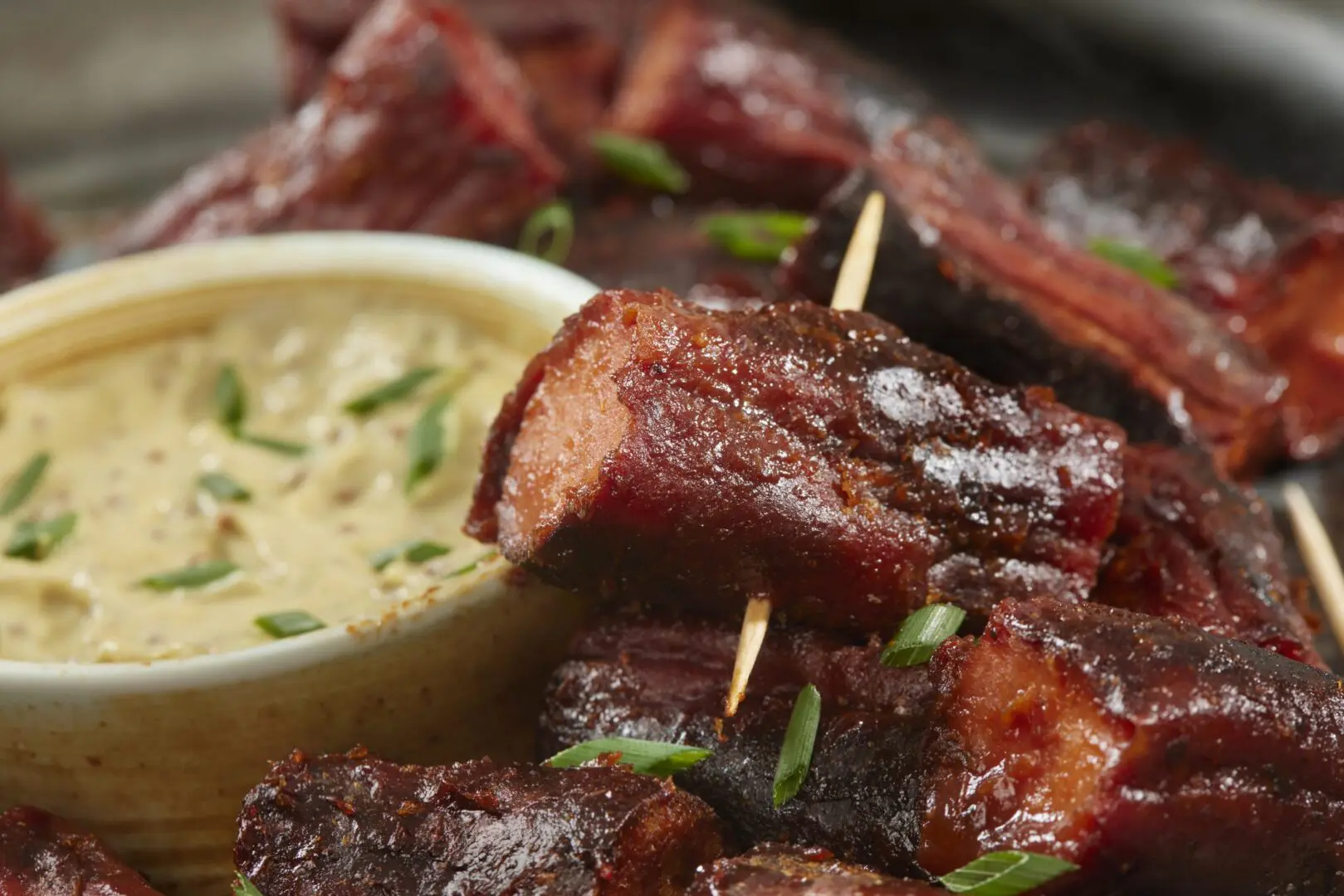 Skewered barbecue pork bites with dipping sauce