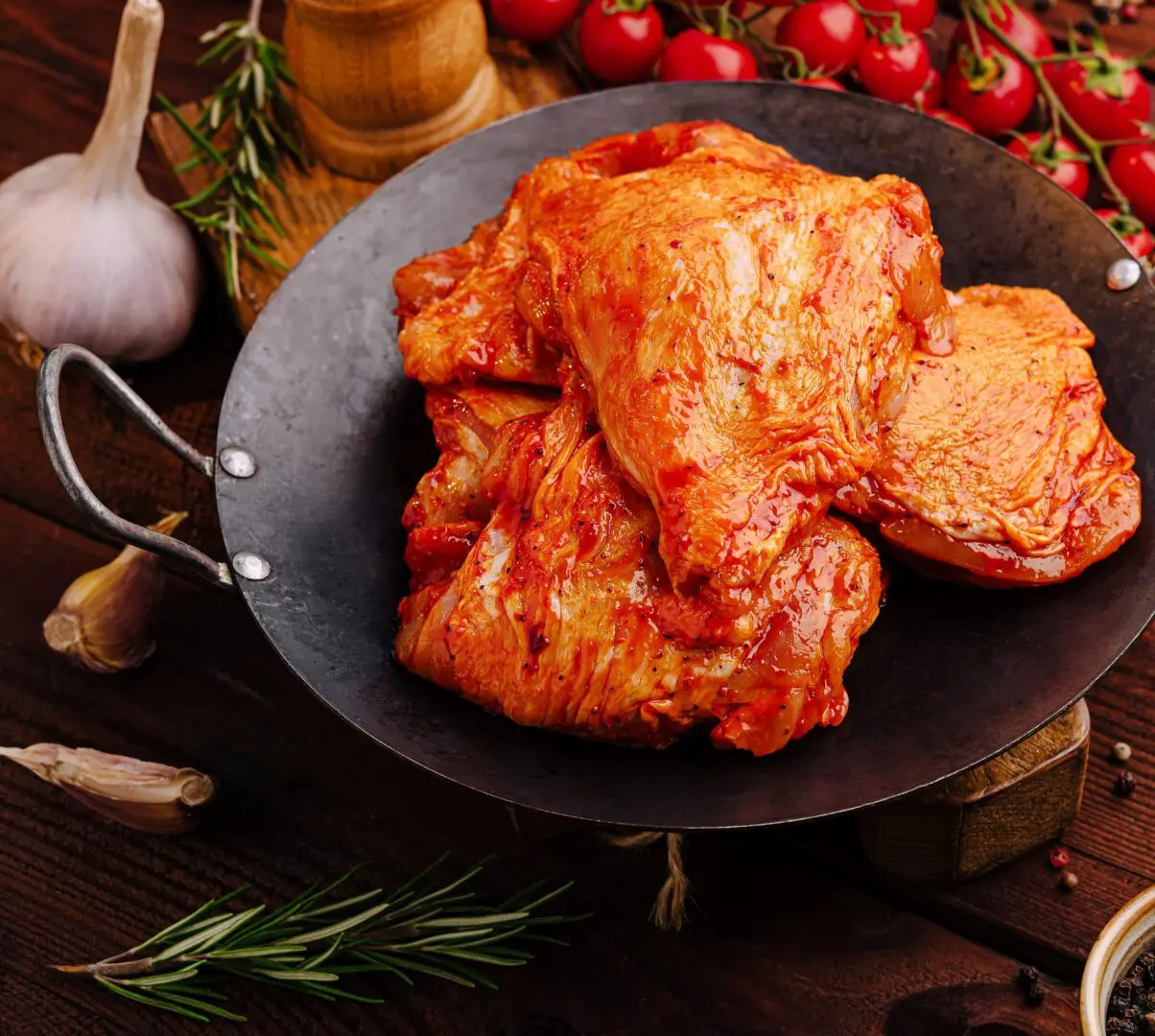 Spicy marinated chicken thighs in cast-iron skillet
