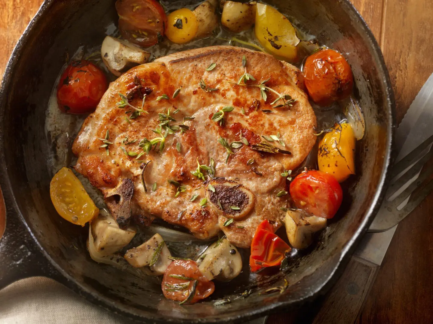 Skillet pork chop with roasted cherry tomatoes
