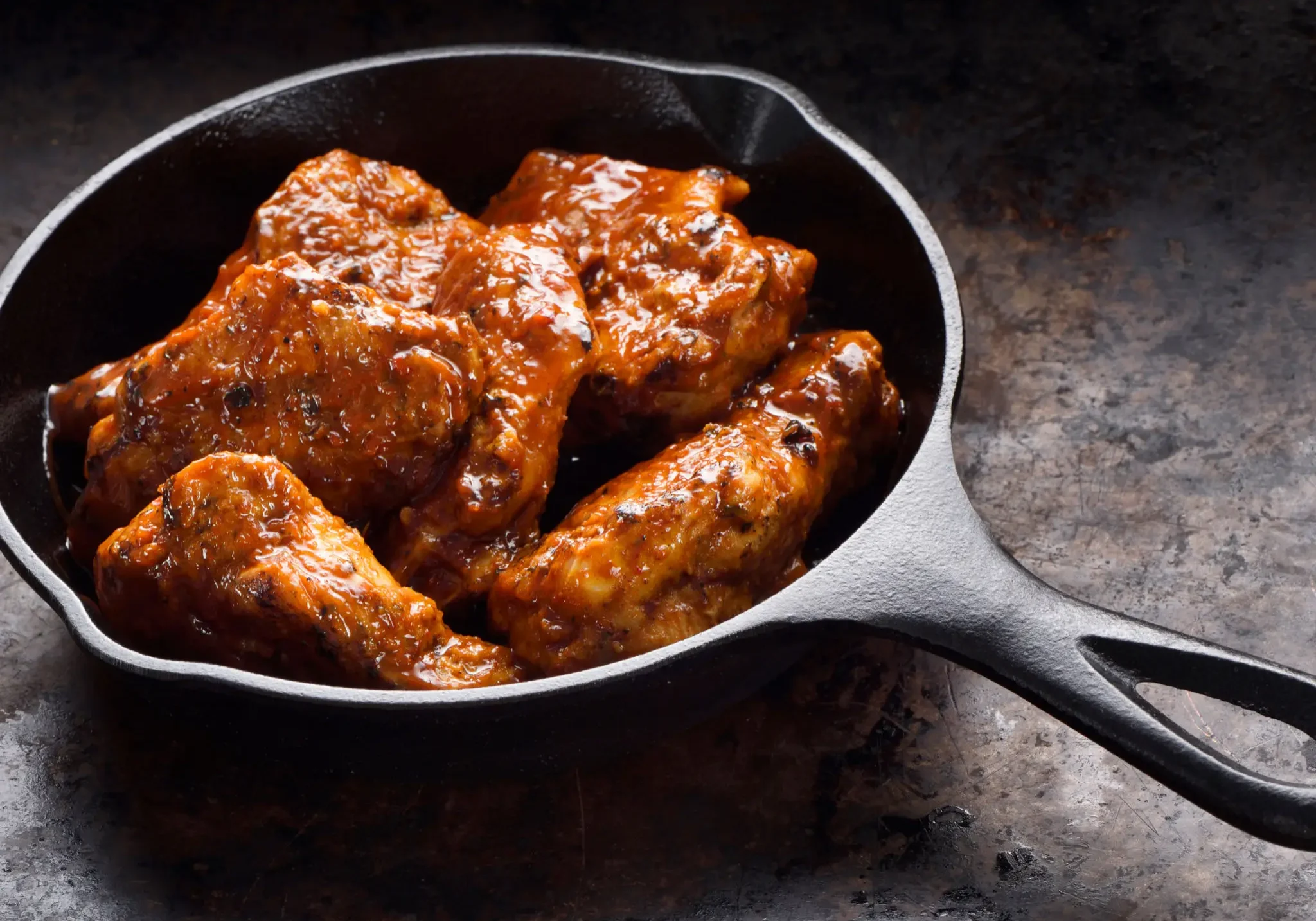 Glazed ribs in a dark skillet