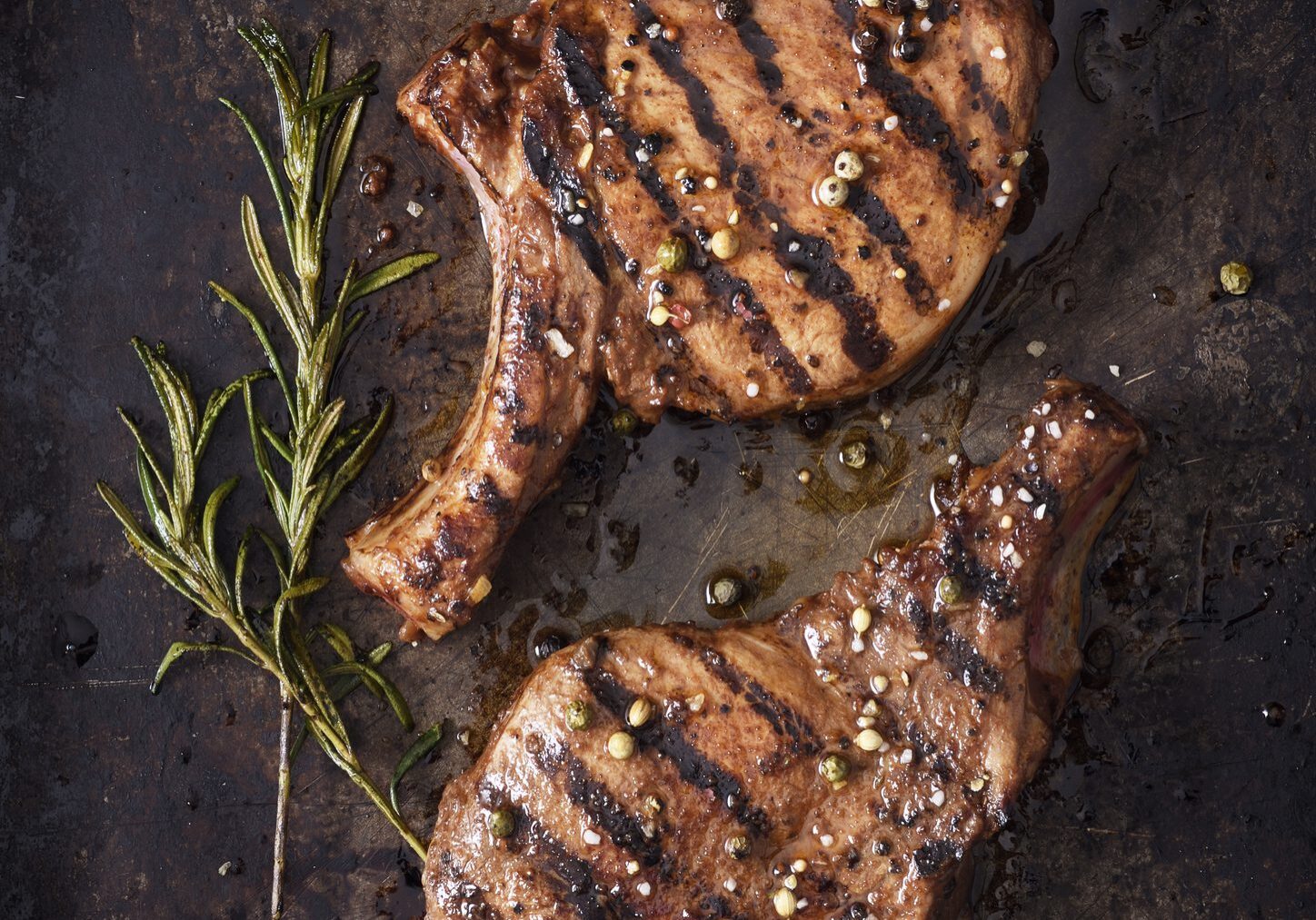 Grilled ribeye steaks with rosemary and peppercorns